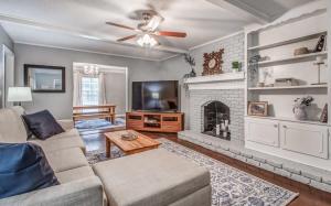a living room with a couch and a fireplace at Happy on Haddington- Easy access to I-240 in Memphis