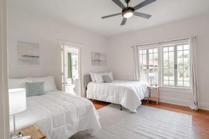 a white bedroom with two beds and a ceiling fan at Mins to Cruise Terminal&Downtown- Sunny Splendor in Mobile
