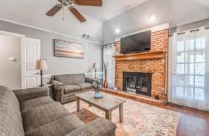 a living room with a couch and a fireplace at Fenced Yard - Comfy & Convenient in Cordova in Memphis