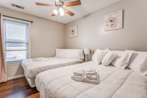 a living room with two beds and a ceiling fan at Fenced Yard - Comfy & Convenient in Cordova in Memphis