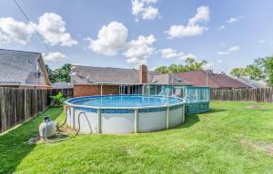 a pool in the yard of a house at Fenced Yard - Comfy & Convenient in Cordova in Memphis