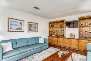 a living room with a blue couch and a table at Brilliant in Bellview-Back unit-- Mins to NAS Pensacola, Beach, Shopping in Pensacola