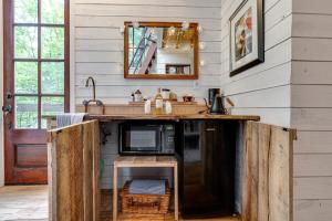 a kitchen with a counter with a microwave in it at Treetop Hideaways: The Dogwood Treehouse in Chattanooga
