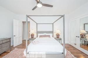 een slaapkamer met een hemelbed en een plafondventilator bij California Dreamin'- Close to Medical District in Augusta