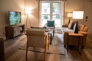 a living room with a couch and a tv at The Cozy Getaway Grill & Roku at Your Convenience! in Huntsville