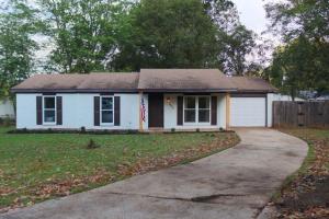 a small white house with a driveway at The Cozy Getaway Grill & Roku at Your Convenience! in Huntsville