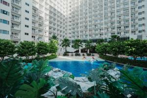 an aerial view of a large apartment building with a swimming pool at Hawaii Suite by Guest Reservations Manila in Manila