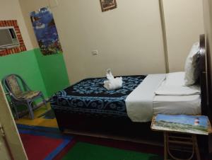 a bedroom with a bed with a stuffed animal on it at Bob Marley Peace hostels luxor in Luxor