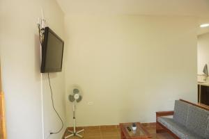 a living room with a flat screen tv on a wall at HABITACIONES PRIVADAS in Tarapoto