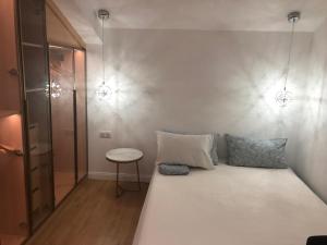 a bedroom with a large white bed and a table at Appartement d'architecte en extra centre de Saint Denis in Saint-Denis +12 photos