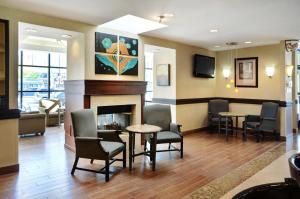 a waiting room with chairs and a fireplace at Holiday Inn & Suites Winnipeg Downtown, an IHG Hotel in Winnipeg