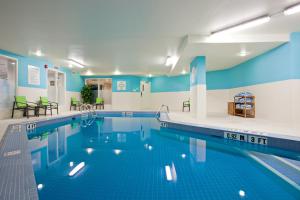 a swimming pool with blue and white walls at Holiday Inn & Suites Winnipeg Downtown, an IHG Hotel in Winnipeg