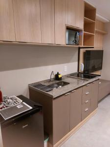an empty kitchen with a sink and a stove at Studio Concept Panamby - Ao Lado do Metrô in Sao Paulo