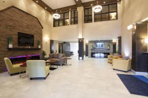 a lobby with couches and chairs and a fireplace at Holiday Inn Express Fort St John, an IHG Hotel in Fort Saint John