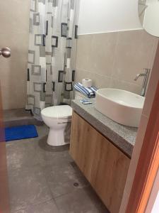 a bathroom with a sink and a toilet and a shower at Departamento 401 - NAREA in Pimentel