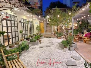 a courtyard with a lot of potted plants at Labri Home Da Lat in Da Lat