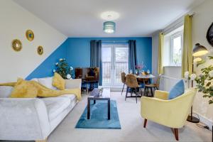 Modern Comfort, 2BR, Ensuite, Parking في رغبي: غرفة معيشة مع أريكة بيضاء وجدار أزرق