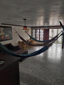 a room with a hammock in the middle of a room at Hotel - La Perla Del Caribe in Ríohacha