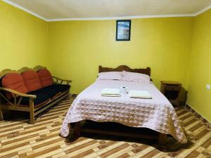 a bedroom with a bed with two towels on it at Dream House B&B in Huaraz