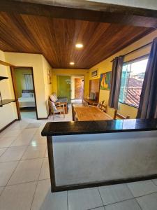 uma cozinha e sala de estar com tecto em madeira em Apartamento Buziano em Búzios