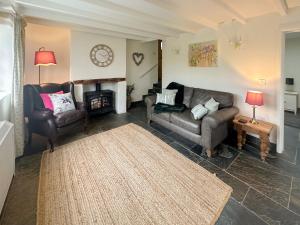 a living room with two couches and a fireplace at Millies Place in Saint Stephen