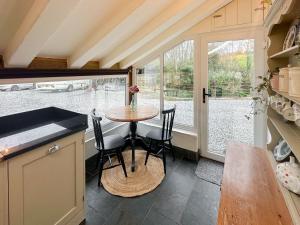 a kitchen with a table and chairs in a tiny house at Millies Place in Saint Stephen