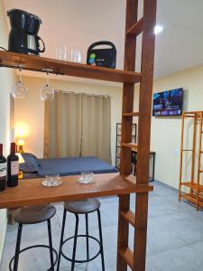 a room with a bunk bed and two bar stools at Suítes Recanto Petrópolis in Petrópolis