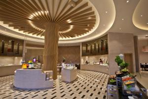 a lobby with a large tree in the ceiling at Crowne Plaza Zhangzhou, an IHG Hotel in Zhangzhou