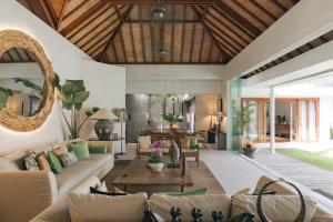 a living room with a couch and a table at Villa Alabali in Seminyak