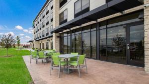 a group of tables and chairs outside of a building at Holiday Inn Express & Suites Racine by IHG in Racine