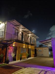 a building with a balcony on top of it at night at Maga hospedagem in Penha
