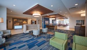 a lobby of a hospital with chairs and tables at Holiday Inn Express & Suites St. John's Airport, an IHG Hotel in St. John's