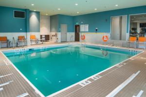 a large swimming pool with blue water in a building at Holiday Inn Express & Suites Victoria-Colwood, an IHG Hotel in Victoria