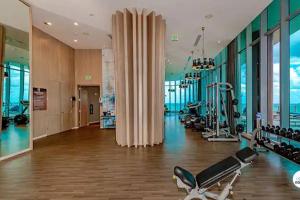 a gym with treadmills and exercise equipment in a building at Komffy Panoramic Oceanview 2BED/2BATH on 38 Floor in Hollywood