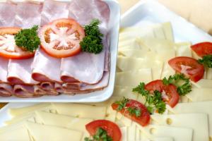 a tray of food with tomatoes and cheese at Holiday Inn Express Zürich Airport by IHG in Rümlang +60 photos