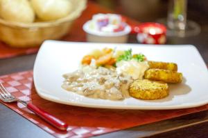 a plate of food with potatoes and vegetables on a table at Holiday Inn Express Zürich Airport by IHG in Rümlang