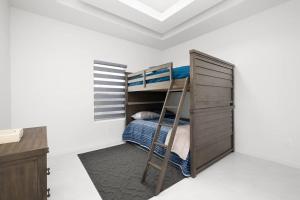 a bedroom with a bunk bed and a ladder at Quinta Real 5133 QR1 in McAllen