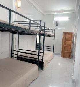 two bunk beds in a room with a bathroom at KING HOMESTAY in Hue