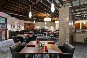 a dining room with tables and chairs in a restaurant at Holiday Inn Oakville Centre by IHG in Oakville