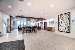 a dining room with a large painting on the wall at Holiday Inn Express & Suites - Calgary Airport Trail NE, an IHG Hotel in Calgary