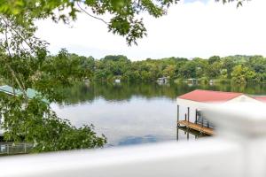 a house on a lake with a dock at Lakefront Cottage near Bristol & Johnson City in Piney Flats