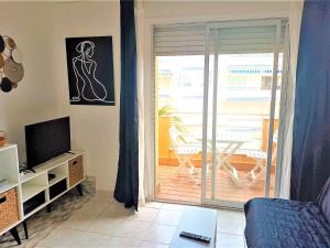 a living room with a sliding glass door to a patio at Apartamento Roses, 1 dormitorio, 4 personas - ES-258-83 in Roses