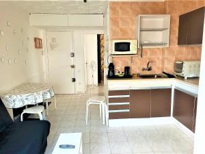 a small kitchen with a sink and a microwave at Apartamento Roses, 1 dormitorio, 4 personas - ES-258-83 in Roses