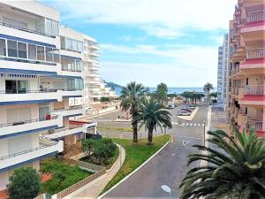 an empty city street with palm trees and buildings at Apartamento Roses, 1 dormitorio, 4 personas - ES-258-83 in Roses