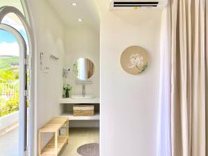 a bathroom with a sink and a mirror at Lotus Home Quảng Ngãi in Quảng Ngãi