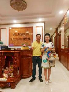 a man and a woman standing in a room at Khách Sạn Tường Vy in An HÃ²a