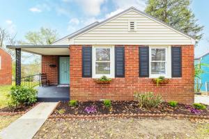 een stenen huis met zwarte luiken en een veranda bij 3BR Cottage Near Downtown Kingsport in Kingsport