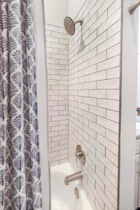 a white bathroom with a shower with a sink at Brand new luxury 2BR loft in downtown Johnson City in Johnson City