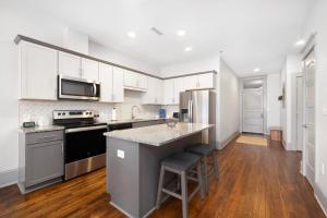 a kitchen with white cabinets and a counter top at Brand new luxury 2BR loft in downtown Johnson City in Johnson City