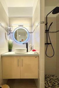 a bathroom with a sink and a mirror at La Saranah - Blue Dream, Piscine, Plage in Grand-Bourg